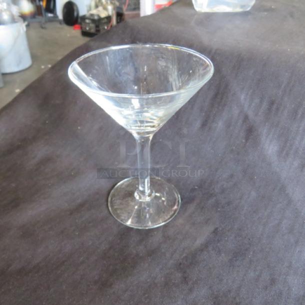 Clear martini/bar glass with a classic V-shaped bowl and slender stem. Appears in good condition on a dark surface.