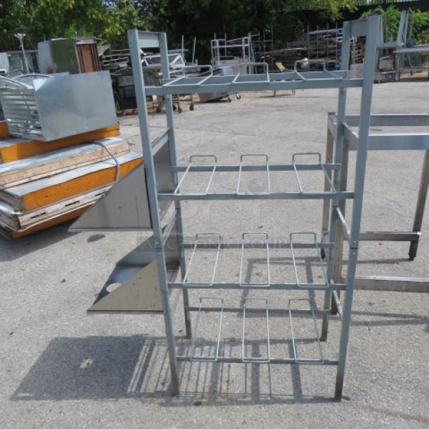 Four-shelf soda racking with two stainless steel side shelves, measuring 41.5x16x57 inches; minor wear visible.