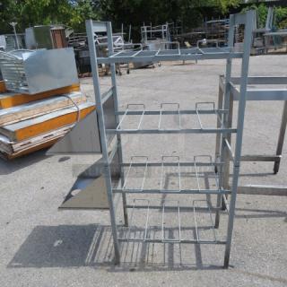 Four-shelf soda racking with two stainless steel side shelves, measuring 41.5x16x57 inches; minor wear visible.