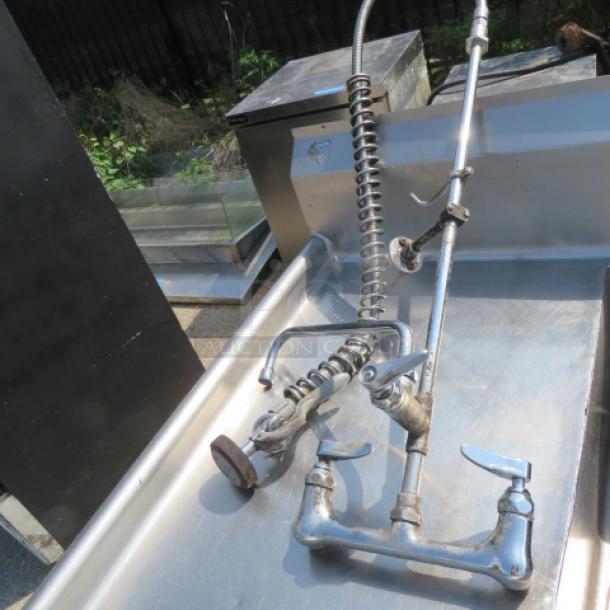 Stainless steel 3-compartment sink with right/left drain boards, faucet, and hose sprayer. Dimensions: 103x35x45 inches.