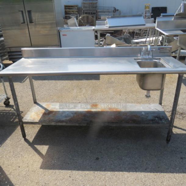 One Eagle stainless steel table with backsplash, under shelf, and sink with faucet, 72x25x38 inches, used condition.