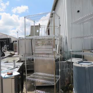 Metal Metro shelving unit with 5 shelves, measuring 30x18x87 inches, in used condition, placed outdoors.