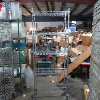 Metro shelving unit with five adjustable wire shelves on casters, measuring 30x14x80 inches. Good condition.