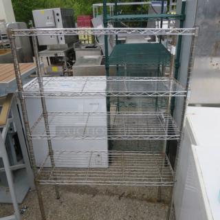 Metro shelving unit with four wire shelves, dimensions 36x14x55 inches, used condition, suitable for storage.