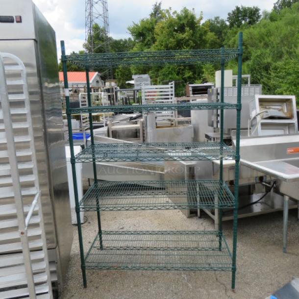 Green Metro shelving unit with 5 wire shelves, dimensions 48x24x75.5 inches, in good condition, suitable for storage.