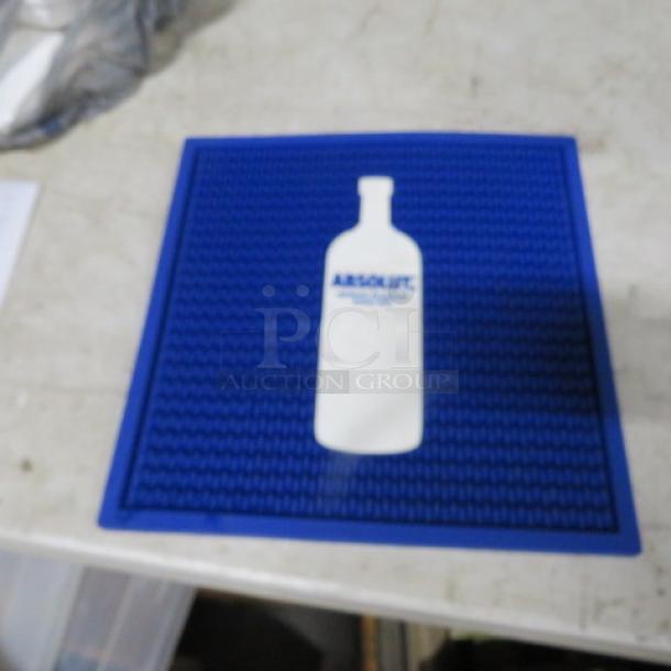 Blue Absolut Vodka bar mat, 14x14 inches, featuring white bottle silhouette. Clean condition, textured rubber surface.