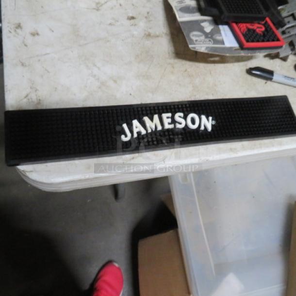 Jameson bar mat, black with white logo, rectangular, textured rubber surface, in good condition.