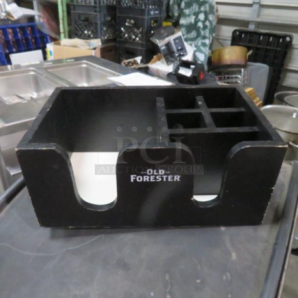 Old Forester wooden bar center with compartments, black finish, used condition, brand name displayed on front.