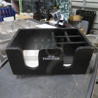 Old Forester wooden bar center with compartments, black finish, used condition, brand name displayed on front.