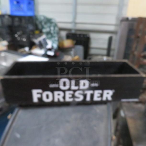 Wooden Old Forrester box, rectangular, black with white logo, vintage condition, open top, collectible item.