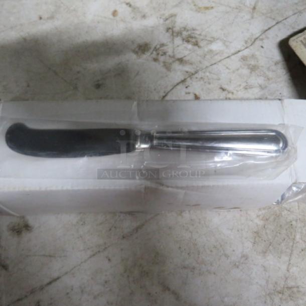 One dozen new solid handle butter knives, sealed in clear packaging, showing sleek metallic design and smooth blade.
