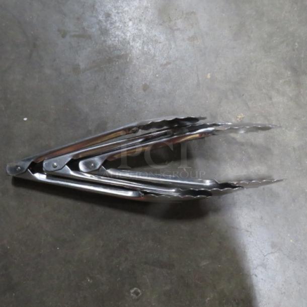 Stainless steel 9-inch tongs, excellent condition, features scalloped edges for grip, ideal for cooking or serving.