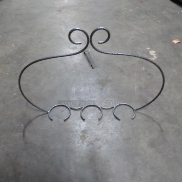 NEW Metal Flight Holder, model 2XBID. Black wrought iron with four circular glass holders, ornate swirl design, pristine condition.
