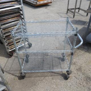 Metro 3-shelf metal cart on casters, dimensions 18x34x34 inches, wire shelves, used condition, sturdy handle.