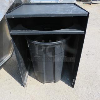 Black metal trash receptacle with trash can, dimensions 27x24x39 inches. Features durable construction, minor wear.