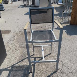 BFM bar height patio arm chair with teak, aluminum frame, mesh back and seat. Outdoor use, good condition.