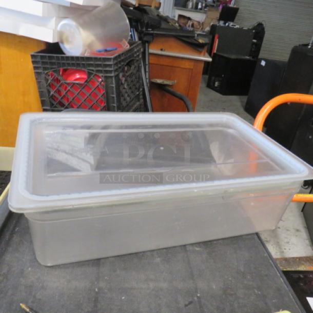 Clear 6-inch deep full-size food storage container with lid, in good condition. Ideal for storing bulk items.