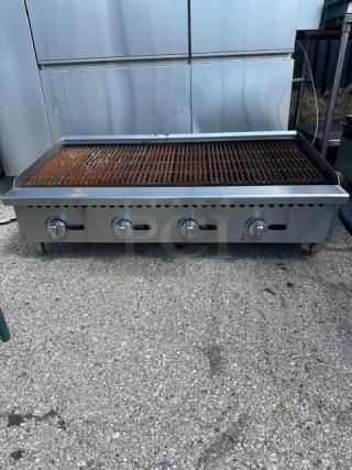Natural gas charbroiler, 48x28x15 inches, stainless steel, four control knobs, used condition with rust on grill surface.