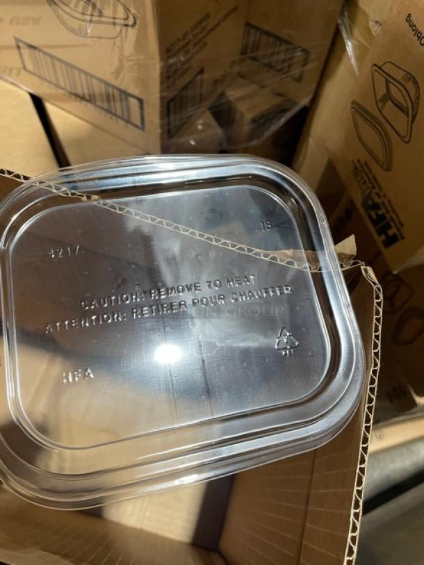 Pile of HFA Gourmet-To-Go aluminum containers with clear lids, model 421745150WDL, 150 per case, new condition.