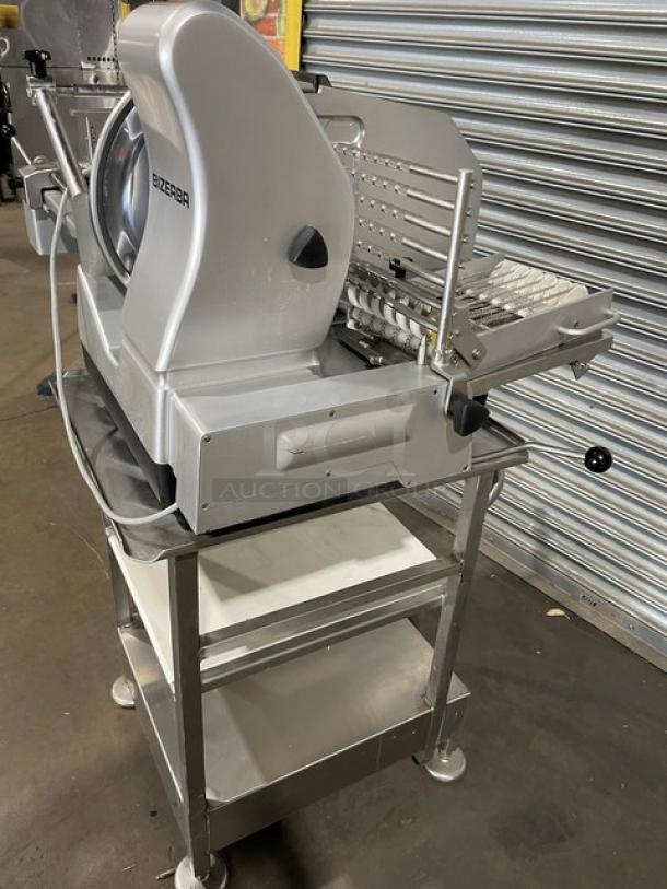 Bizerba VS12DV commercial electric deli slicer with undershelf table and retractable casters, in good condition.