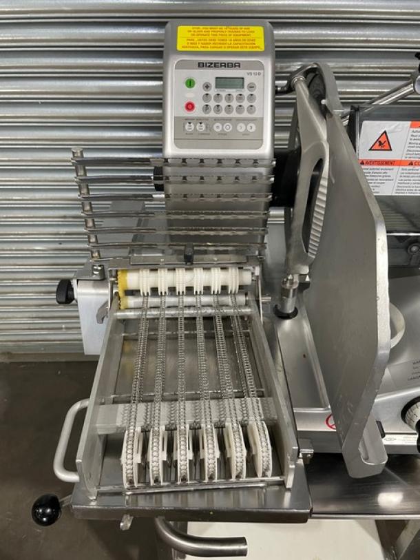 Bizerba VS12DV commercial electric deli slicer with automatic shingle/stacking, undershelf stand, and retractable casters.