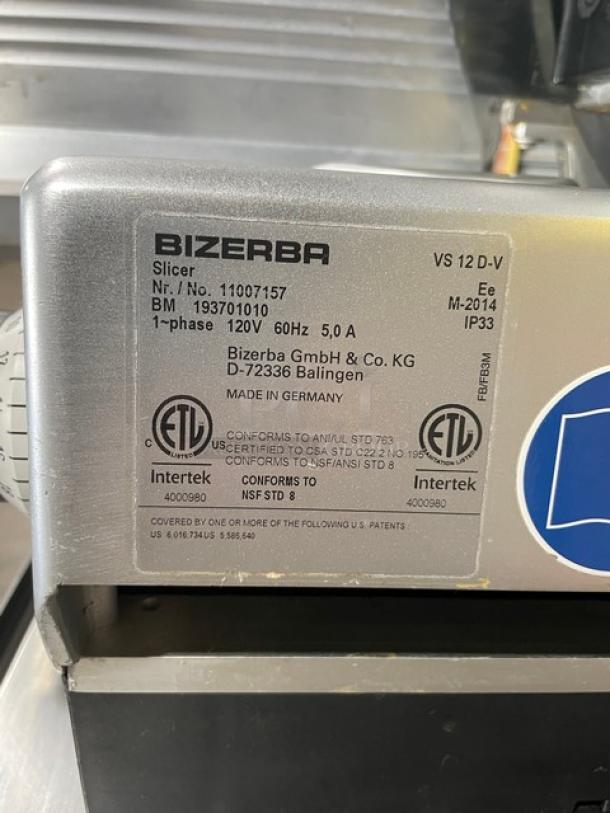 Bizerba VS12DV electric meat slicer, serial 11007157, on undershelf stand with casters; 120V, used condition, label shows specs.