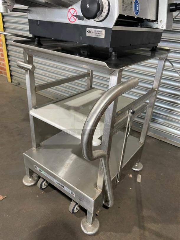 Bizerba VS12DV commercial deli slicer on equipment stand with retractable casters; features include vertical slicing and stacking.