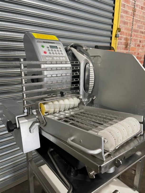 Bizerba VS12DV commercial deli slicer, electric-powered, with undershelf stand, retractable casters, in excellent condition.