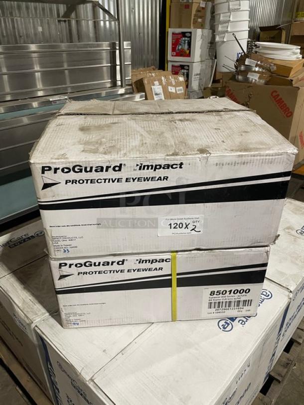 ProGuard Impact protective eyewear boxes, model 8501000, stacked in warehouse, holding 144 pieces each.