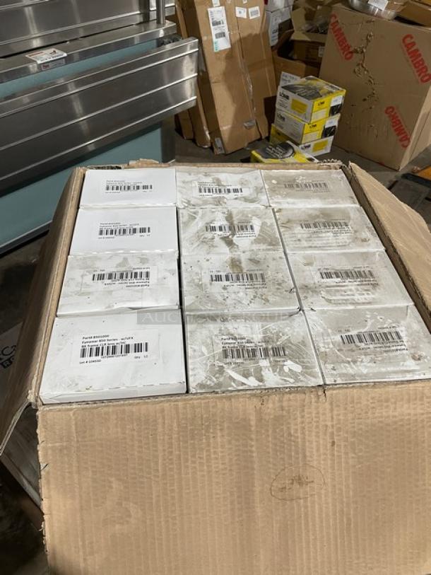 Box of ProGuard Model 8501000 protective eyewear, 144 units per case, new condition. White boxes with product labels visible.