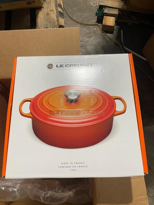 Brand new Le Creuset 6-3/4 Qt. Enameled Cast Iron Oval Dutch Oven with lid, in box, orange color. Made in France.