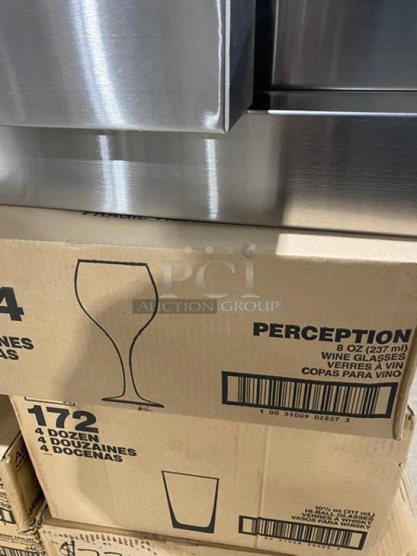 Stacked boxes of Libbey Perception 8 oz wine glasses and Libbey 10.5 oz hi-ball glasses. New in sealed cases.