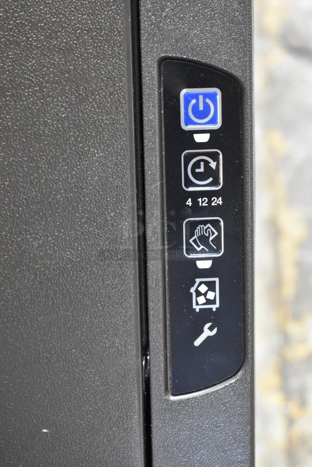 Control panel of the Manitowoc UDF0310A-261Z ice machine, showing power and function icons.