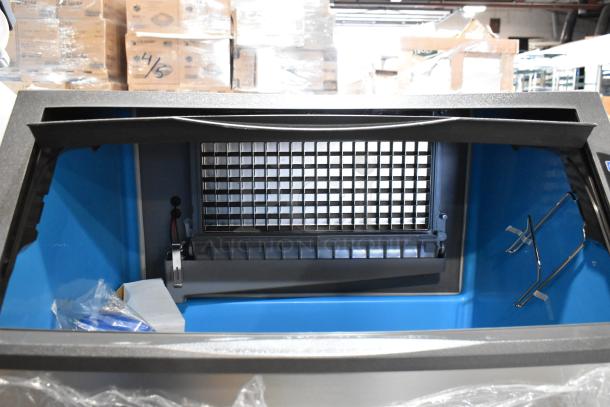Stainless steel Manitowoc UDF0310A-261Z ice machine, 119 lb. bin, 286 lb. capacity, minor dents, interior view.
