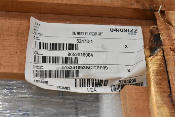 Brand new BKI 52473-1 stainless steel meat freezer in crate. Features commercial casters, 115 volts, 1 phase. Tags show serial 8052018004, condenser 513301693BCITPP39.