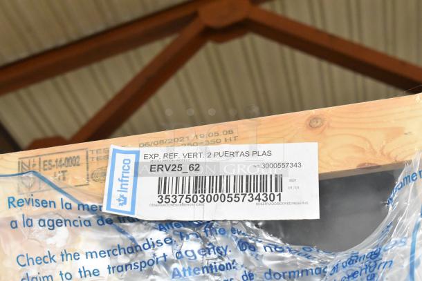 Brand new Infrico ERV25-GD 2-door cooler in crate, metal construction, 115V, 1 phase. Label shows model, serial number.