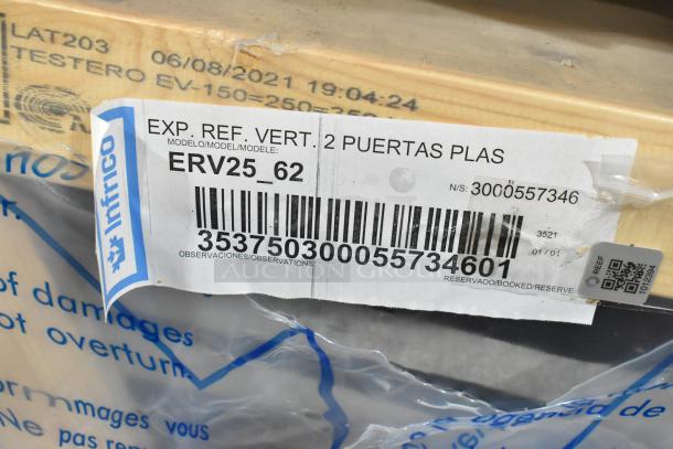 BRAND NEW Infrico ERV25-GD metal commercial 2-door cooler merchandiser in crate. Tags show model, serial, and specs. 115V, 1-phase.