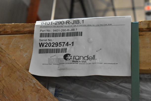 Brand new Randell 9404F-290JIBR stainless steel undercounter freezer in crate. Shows manufacturer's label with model and serial number.