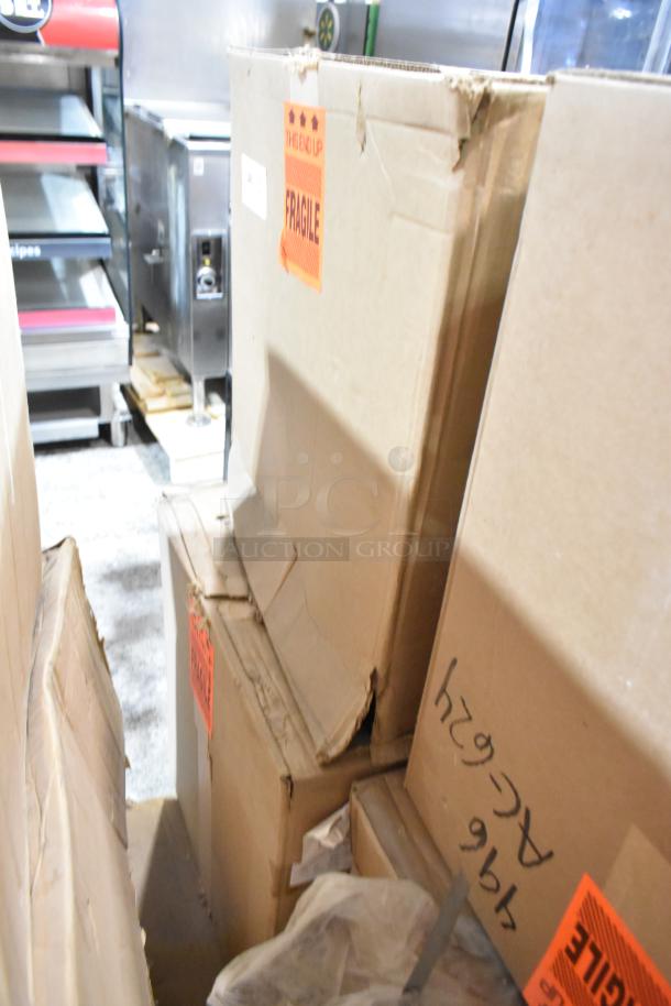 Two brand-new Hoffmann Spectracool units in boxes. Model N170116G010, 1025 BTU, for indoor use. Fragile labels visible.