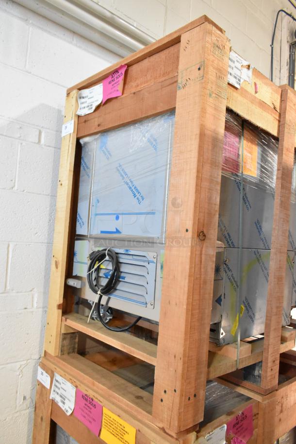 Brand new BKI 52473-1 stainless steel meat freezer, 115V, 1 phase, on casters. Crated with visible labels and markings.