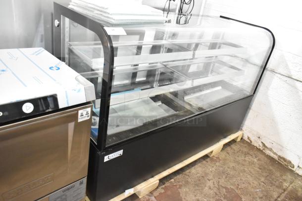 Brand new Avantco 193BC72HCB curved glass bakery display case, black, with visible glass damage. 115 volts, 1 phase.