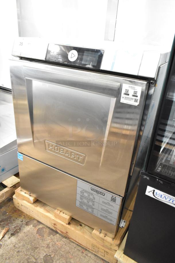 Brand new Hobart LXNH stainless steel undercounter dishwasher, 2025 model. High temp, 120/208-240V, 1 phase. Visible tags.