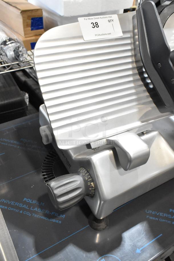 BRAND NEW 2024 Hobart Centerline EDGE12-11 meat slicer, 12" blade, manual, integrated sharpener, 115V, 1 phase. Auction tag visible.