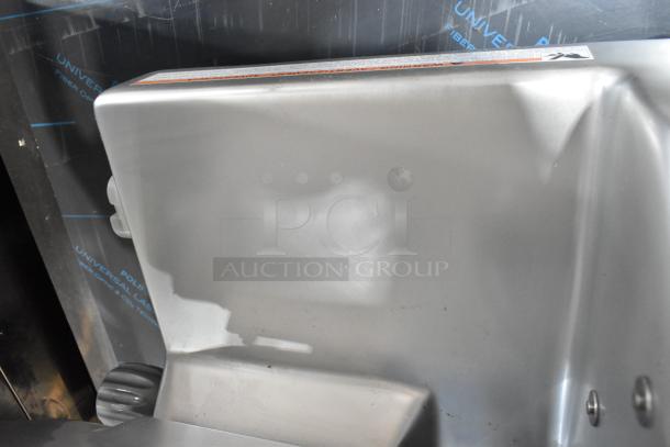 BRAND NEW Hobart EDGE12-11 12" Manual Meat Slicer with Blade Sharpener, 115V, 1 Phase, minor scratches visible.