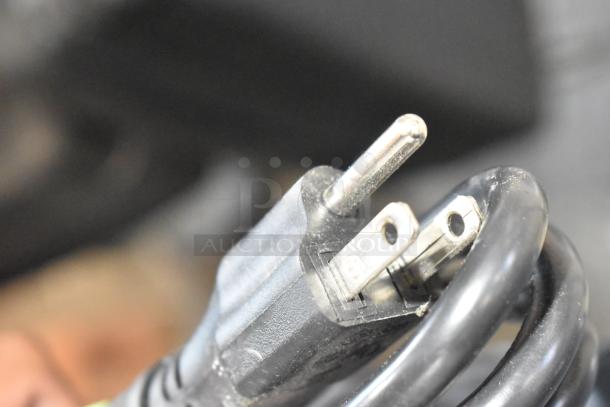 Close-up of a 115V power plug for a 2024 Hobart Centerline EDGE12-11 meat slicer. Black cord shown in detail.