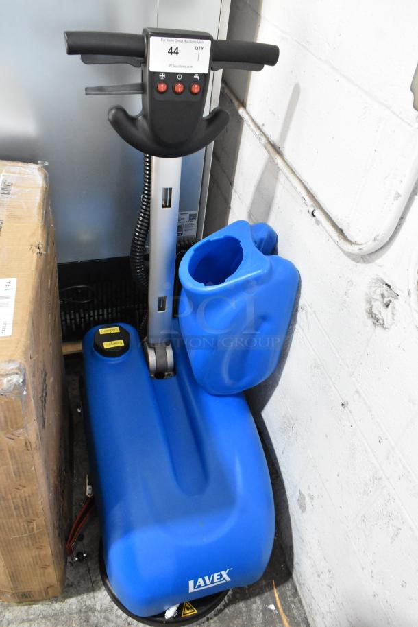 Brand new Lavex 274AFS3BAT 13" AGM cordless floor scrubber. Includes scrub brush, 3-gallon tank. Visible controls and labels.