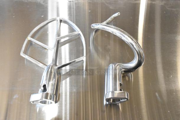 New scratch and dent dough hook and paddle set on metallic surface. Ideal for mixing tasks.