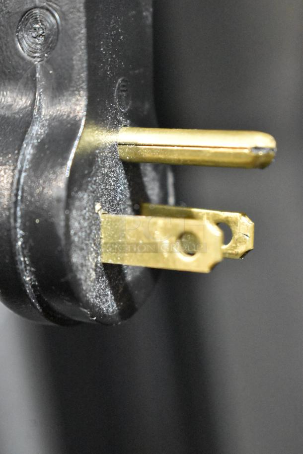 Close-up of a plug for the 2025 Avantco 447AP49R Stainless Steel Commercial 2 Door Reach In Cooler, 115 Volts, 1 Phase.