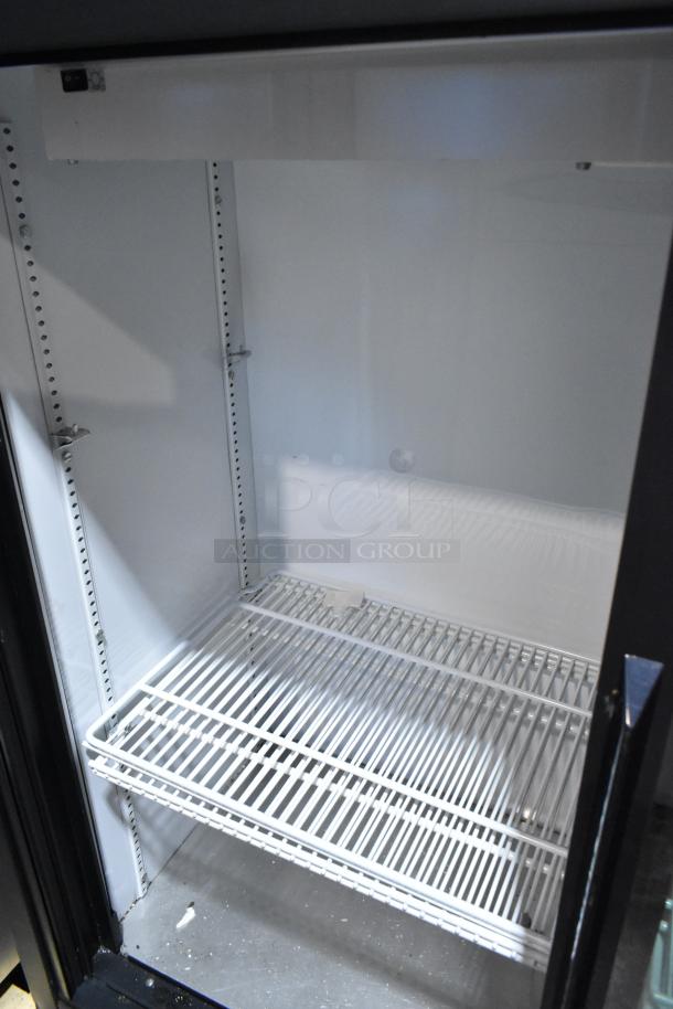 True GDM-41SL-54-LD commercial cooler interior; white poly-coated racks, metal finish, 115V, 1 phase. Clean condition.