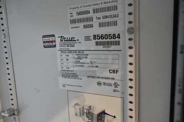 True GDM-41SL-54-LD reach-in cooler label with model, voltage, phase info, and serial number for asset tracking.